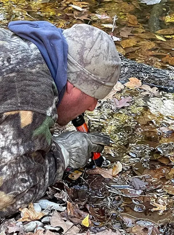 Testing the straw in a mud puddle