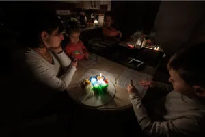 Family by candlelight during a blackout